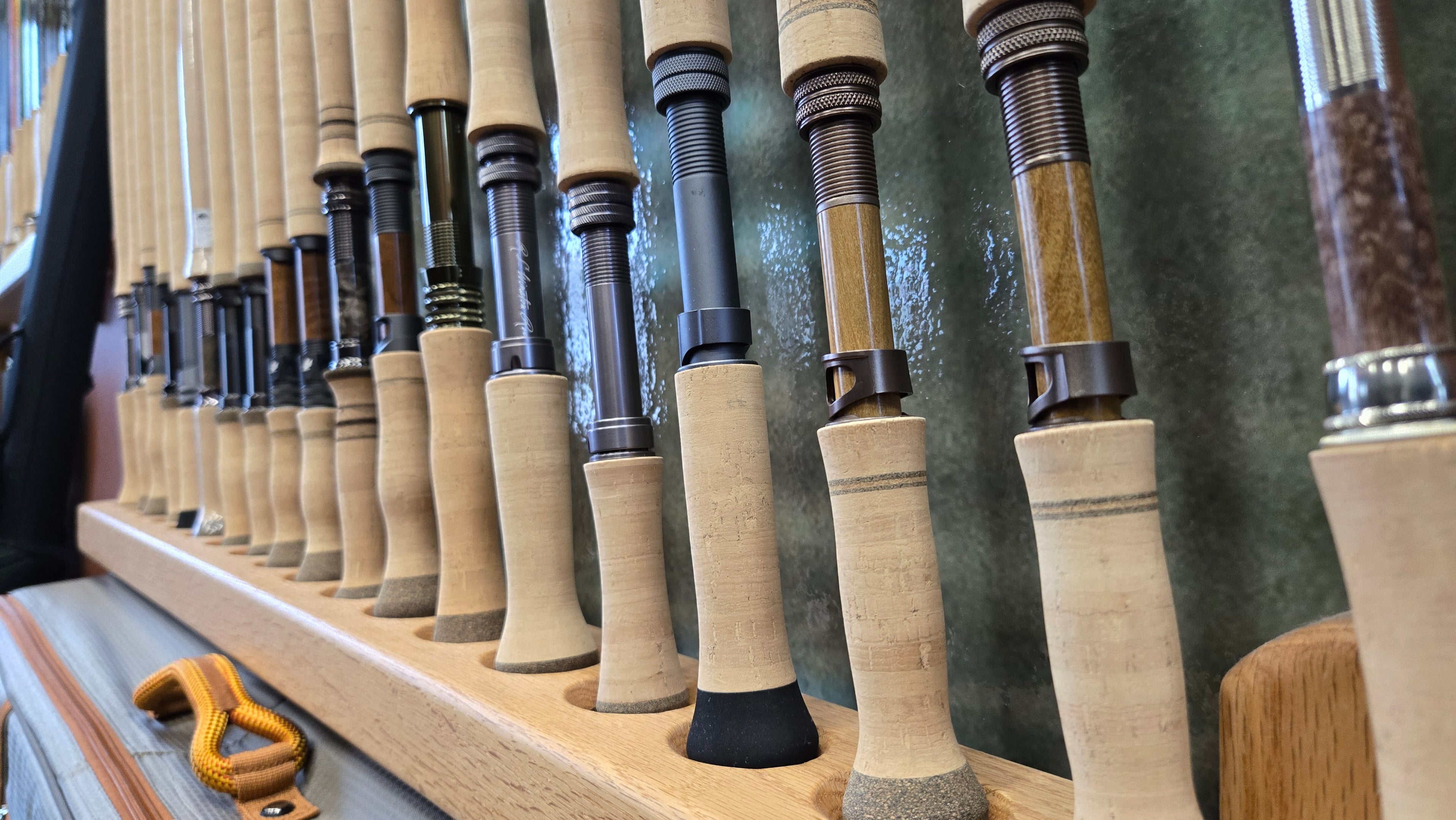 Row of Spey Rod - fishing rod lineup with handles on a display stand with a blurred background