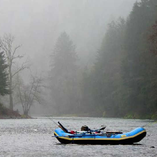 Inflatable boat on a foggy Coastal River