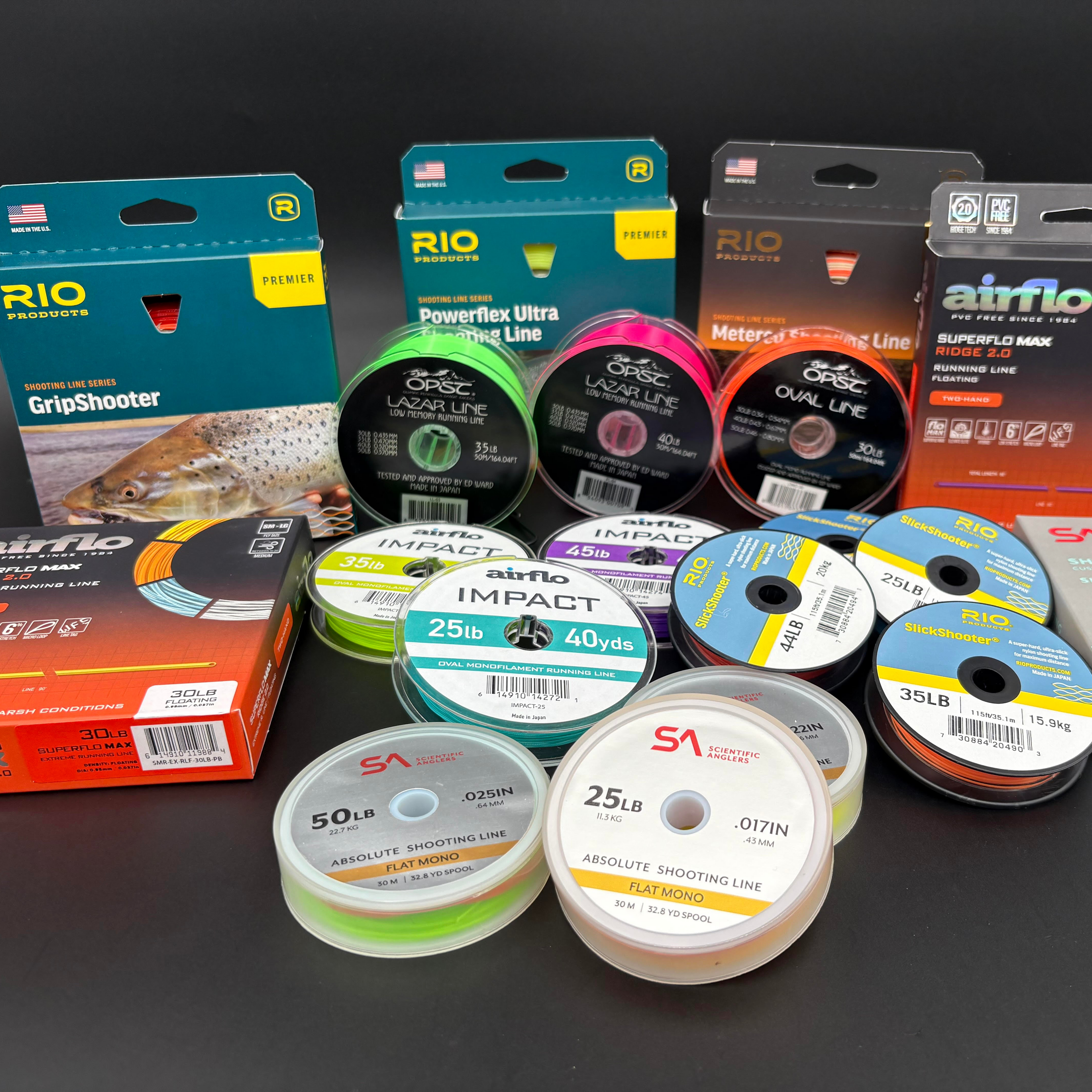 Collection of Running Line, shooting line, spools and packaging of spey lines on a dark background
